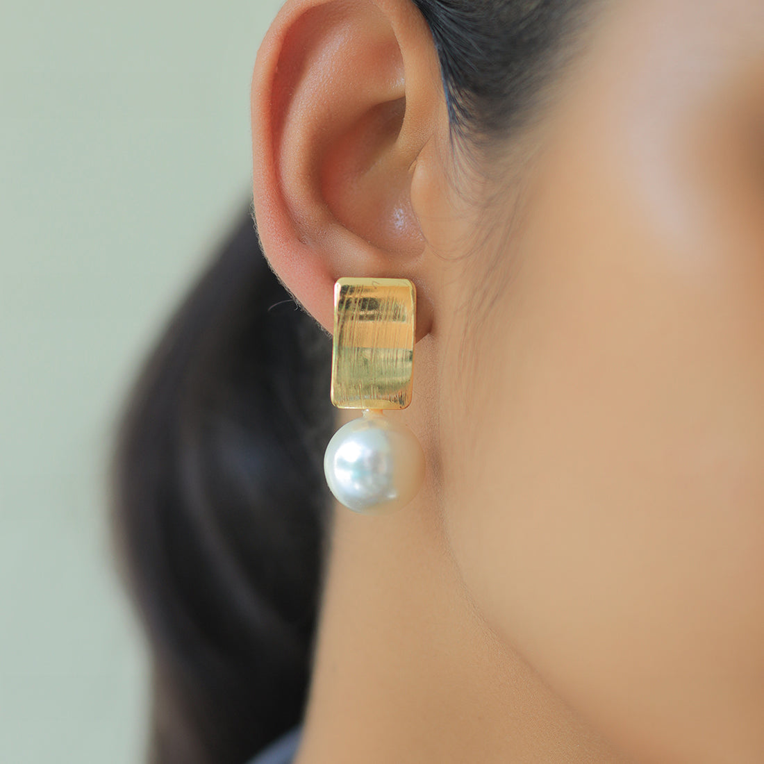Striking Gold Rectangular Earrings Accented With A Chic Pearl.