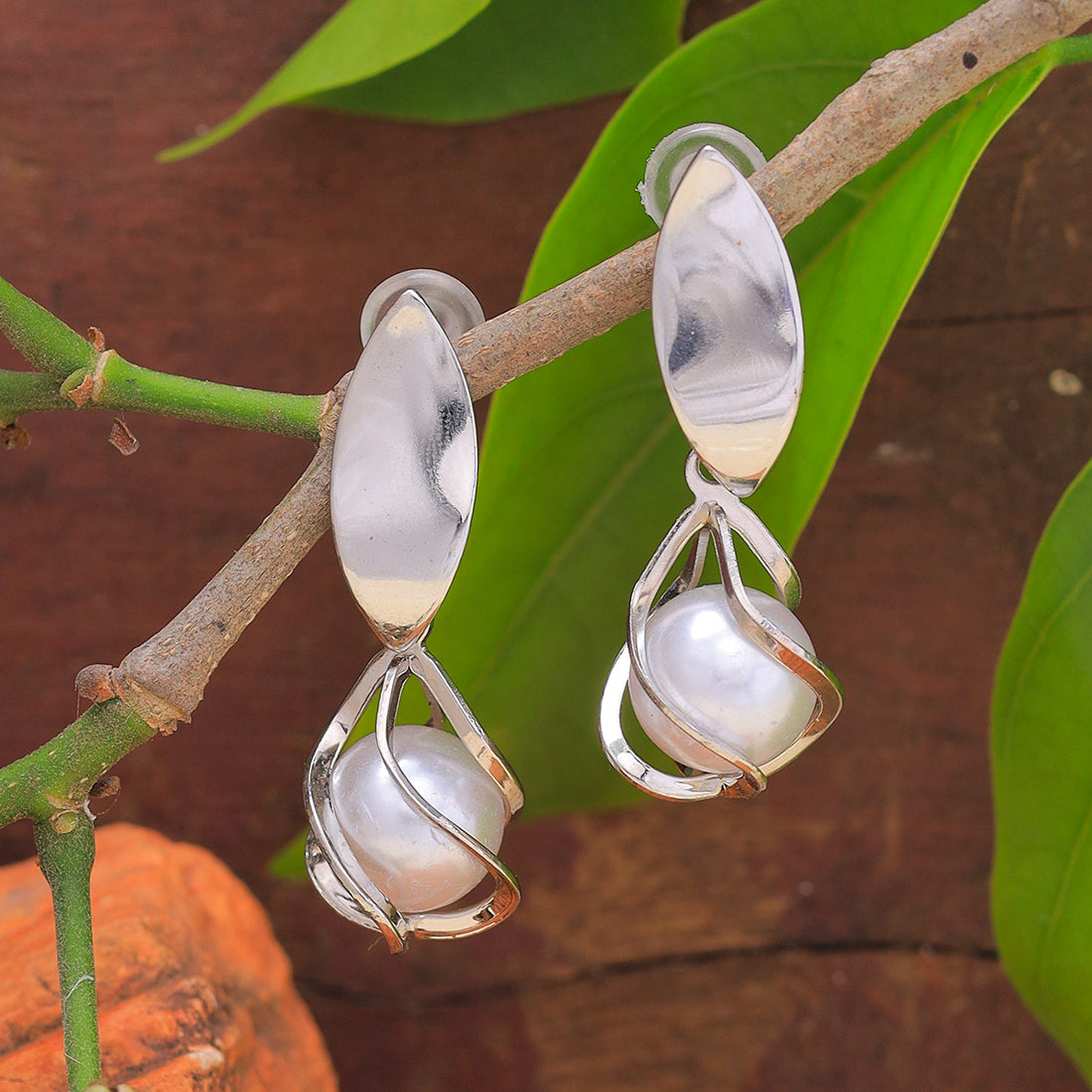 Chic Silver-Toned Earrings With Lustrous Pearl Drops.